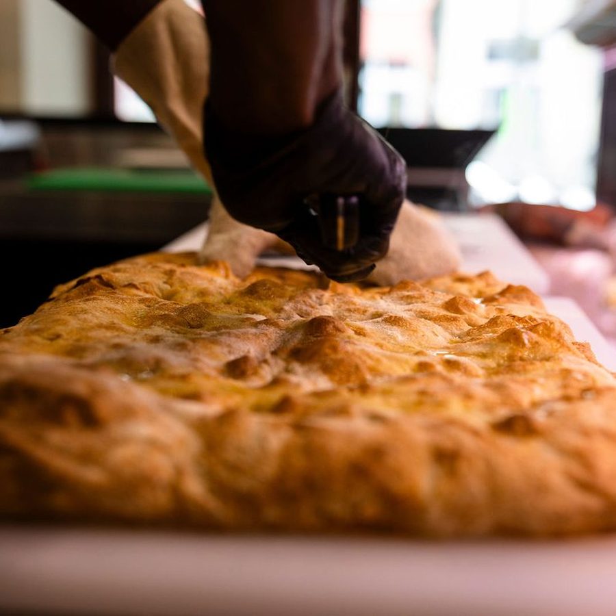 Golden blistered crust of a sourdough schiacciata fresh from the Crosta oven in Berlin